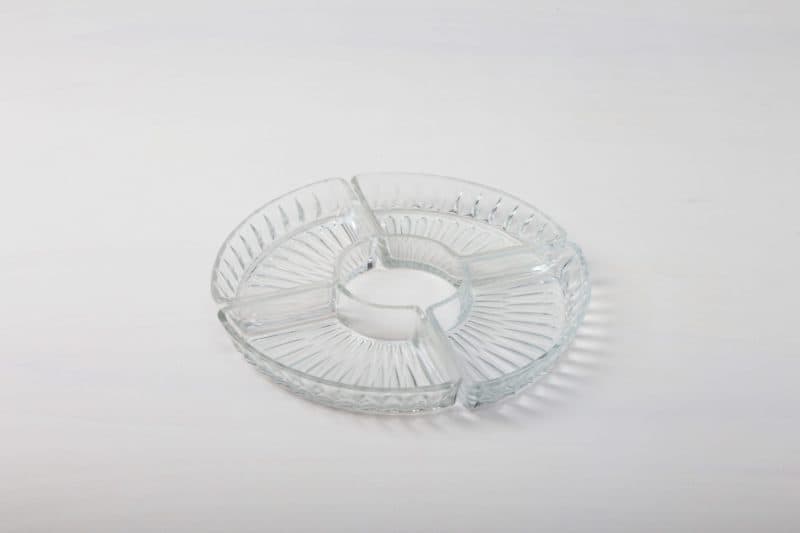  | These delicate, trapezoidal press glass bowls make up a decorative circle in which the most delicious of snacks, whether sweet or savoury, can present themselves excellently. Whether at a wedding or a Christmas party, little chocolates, sweets, nuts or olives always taste delicious from these bowls.The crystal dishes look equally good on the bar trolley, on a big table or at the candy bar. Our crystal carafes and other small bowls in vintage crystal style complete the look. | 