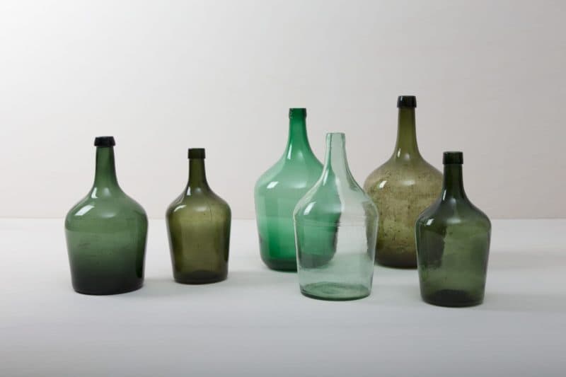  | How many liters of wine may have been made in these demijohn for roaring celebrations? That will probably forever remain a mystery. It is quite clear, however, that these demijohn are a wonderful decoration for your celebration today. Whether alone or as a group, the beautiful, bulbous shapes and different shades of green make them a real feast for the eyes. They are ideal as vases for long grasses or exotic single flowers.The demijohn are available in different sizes. Some are small enough... | 