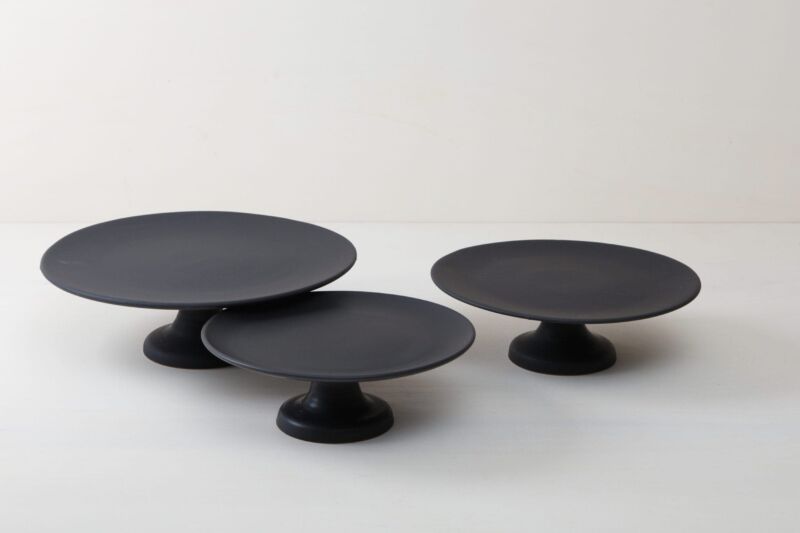  | Our small elevated round cake stand Ernesta rests on a 12 cm high foot and has a diameter of 32 cm. On the matt black serving tray there is space to present and arrange cakes, cupcakes, sushi and other delicacies on the table or at the modern buffet. The serving trays are handcrafted from high-quality terracotta and glazed matt black, obviously food safe.These cake stands are available in three different sizes as well as a matt white serving tray. They can be wonderfully combined for present... | 